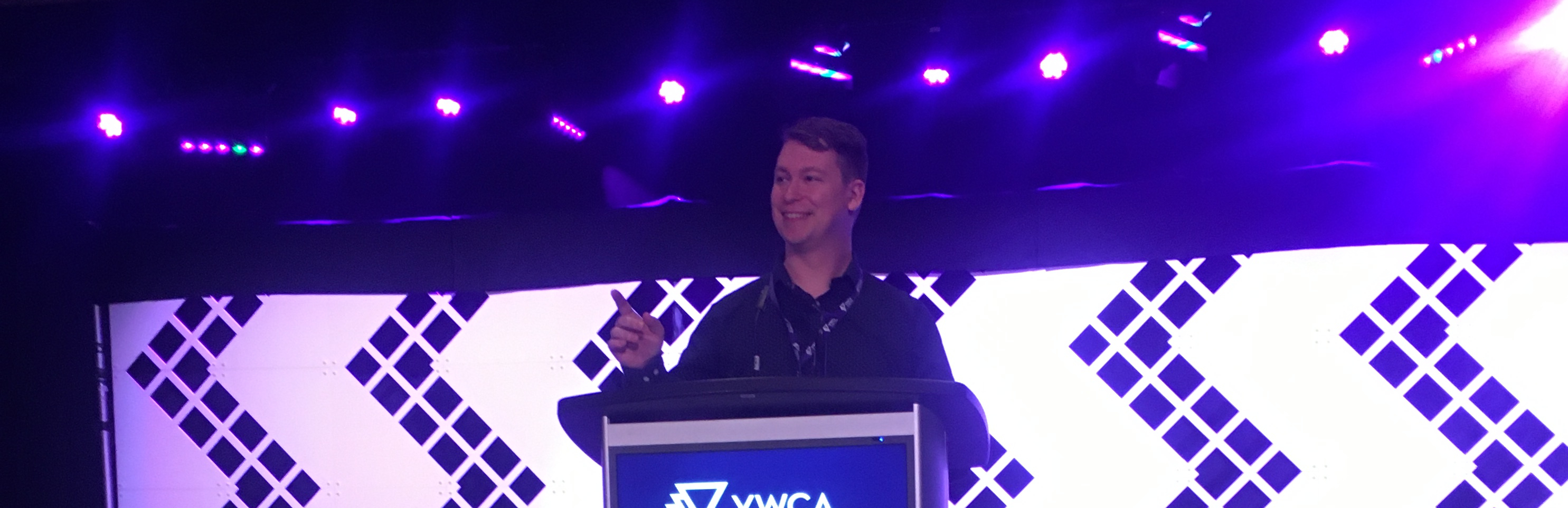 Alex speaking at an event